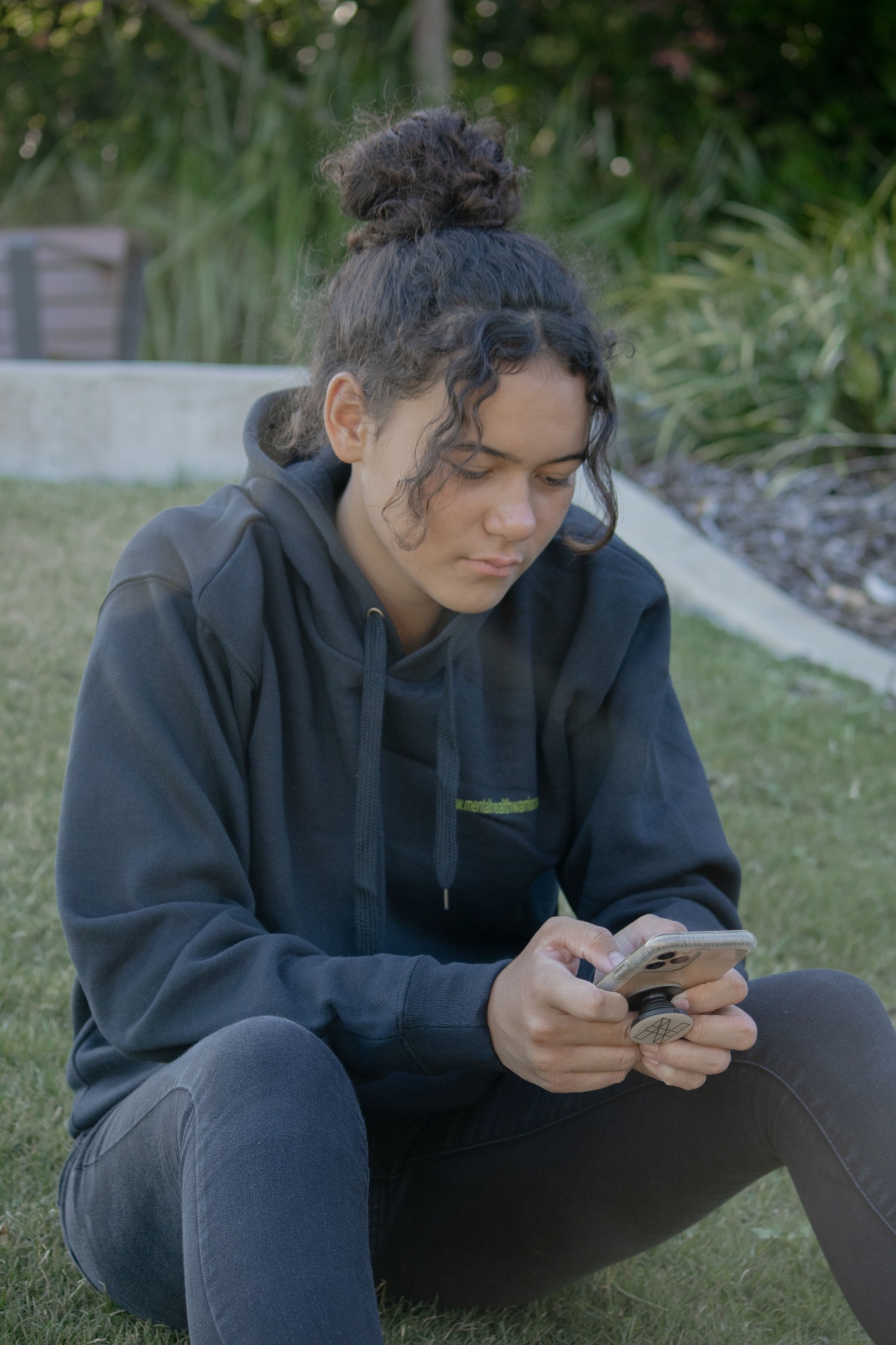 Young person using phone for support