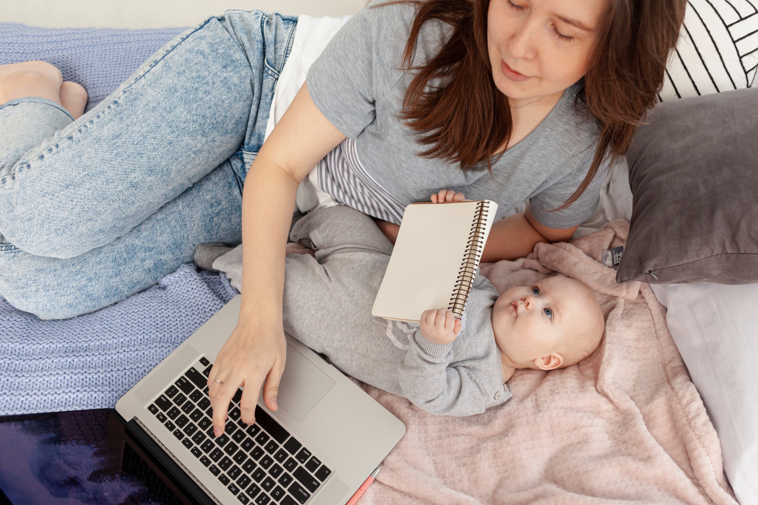 Mother with her baby using a laptop